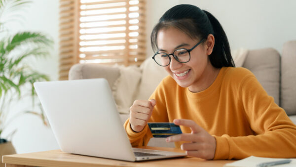 Young woman shops on her laptop