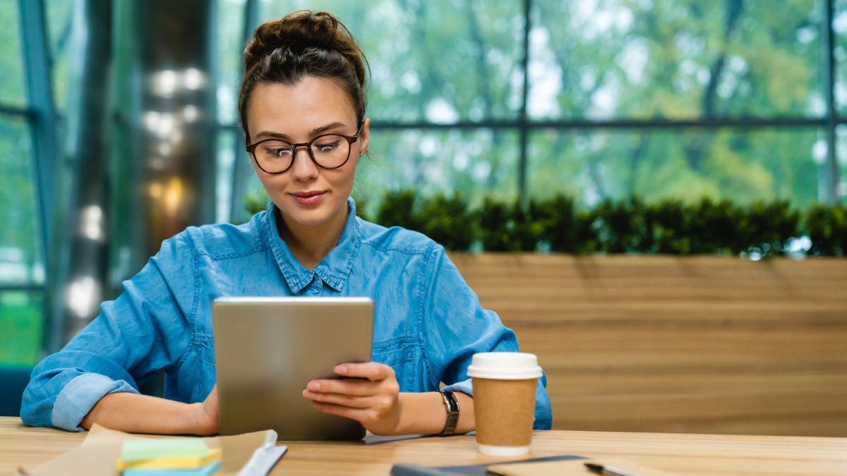 Business woman looks at tablet