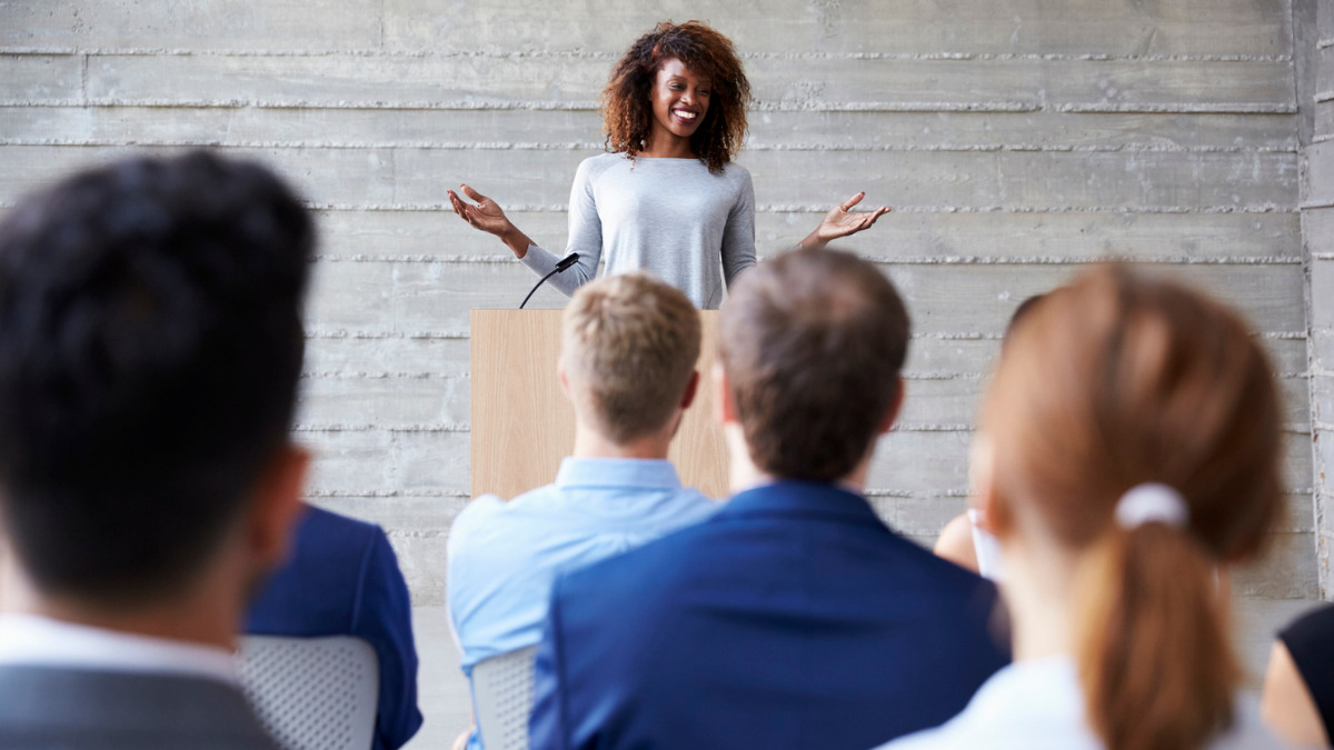 Woman gives presentation to audience