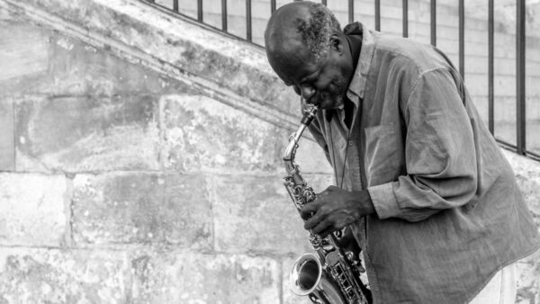 A saxophonist performing during the Harlem Renaissance, representing the era's vibrant music scene.